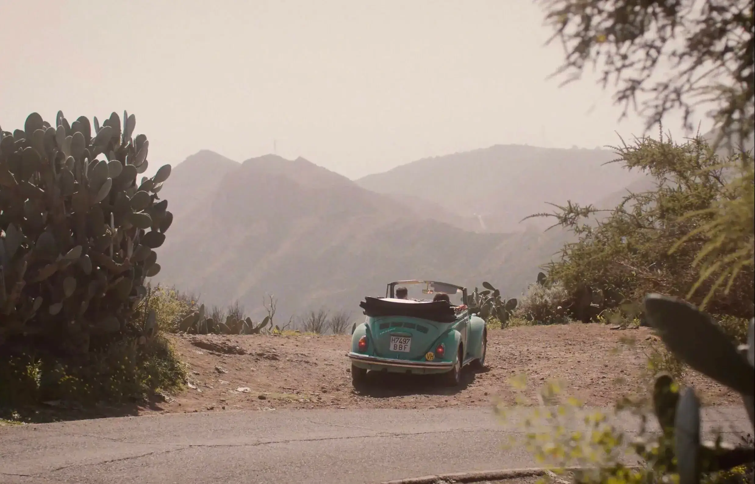 Brand Video Production UK 12 A FatFace model in the front seat of a Beetle Car parked beside a road in Tenerife, Canary Islands.