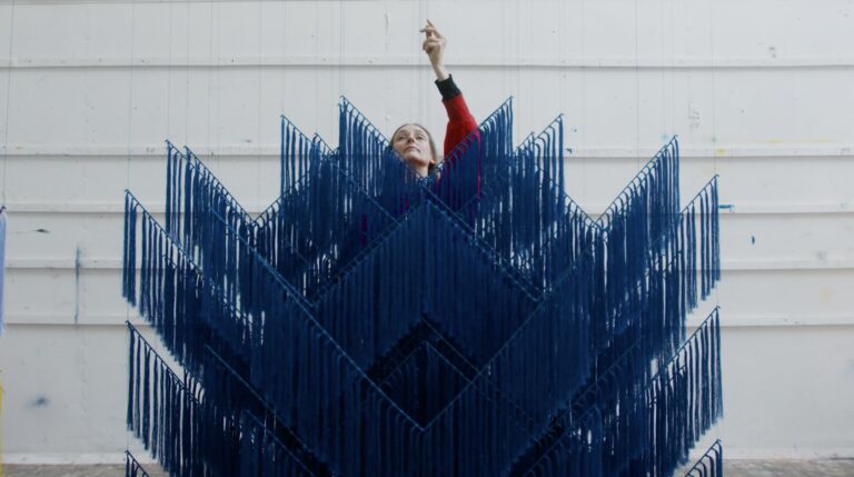an image of Outi Pieski setting up her most recent instillation for the Tate Galleries.