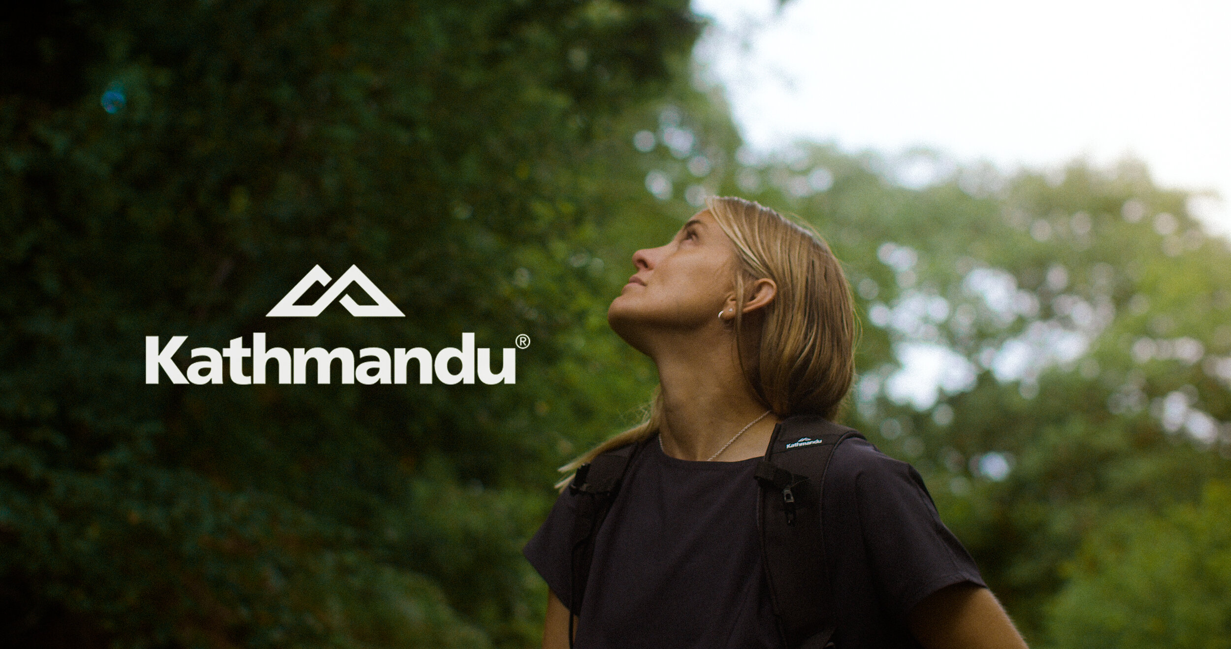 A close up of Sophie Hellyer - cornwall based sustainability influencer - as she looks up at a canopy.