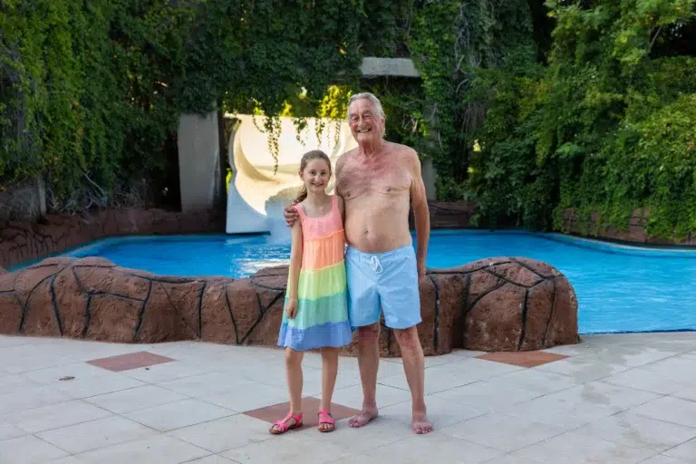 An image of Bob, the TUI Senior Slider winner, and his granddaughter standing infront of a waterslide.