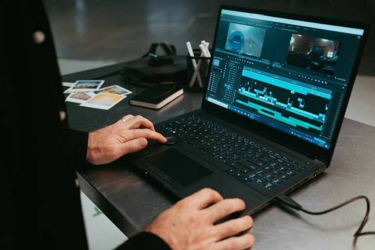 An over the shoulder photo of a DIT uploading footage onto a drive from the laptop.