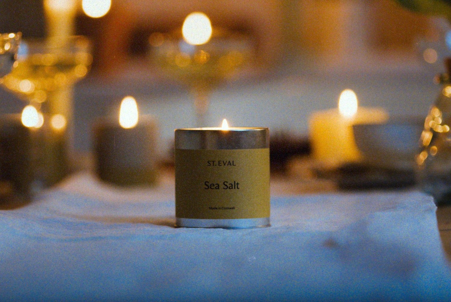 A still frame of a St Eval Candle on a dressed table.