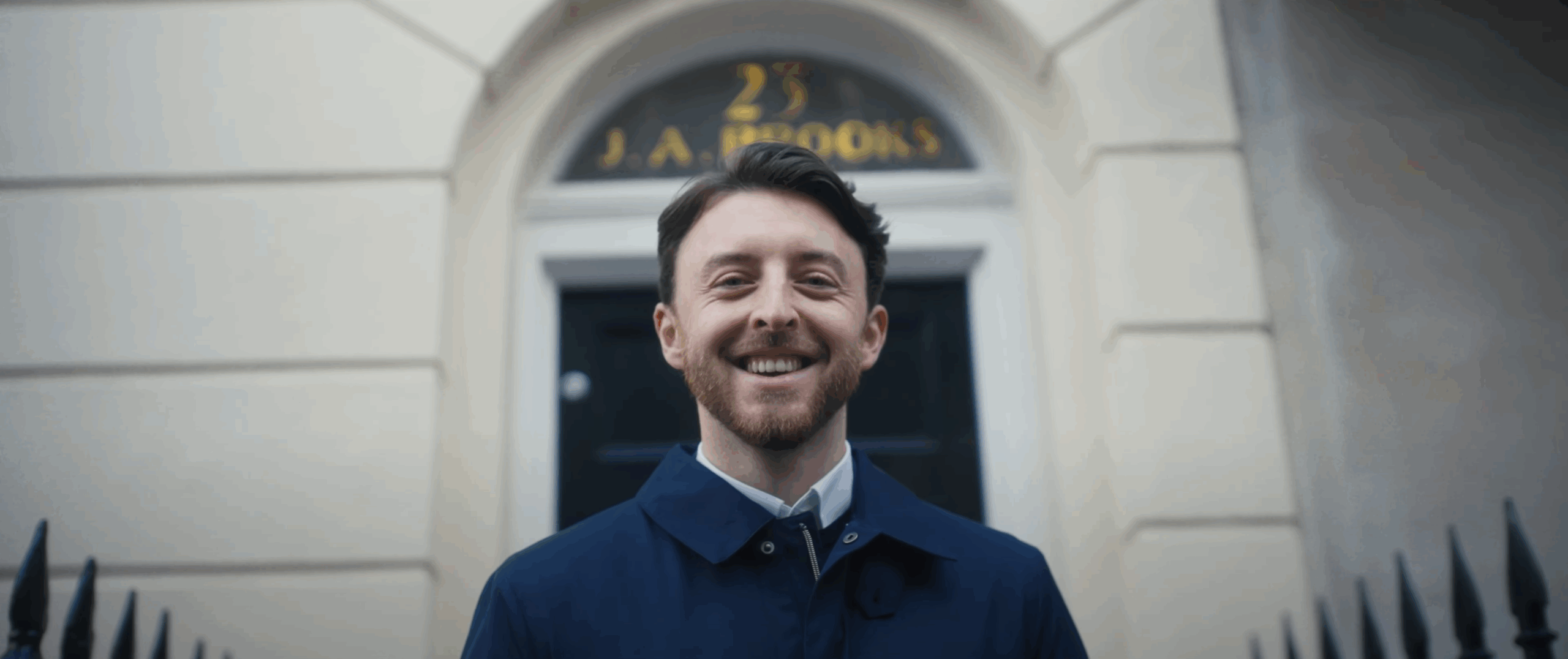 An image of a simply business employee with his arms crossed, smiling, looking straight into the barrel of the lense. Taken during a recent corporate video production for London Based client Centrical software.