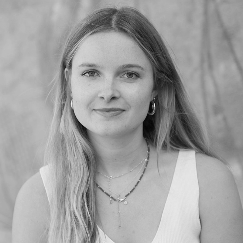 An image of Ed Smit, Managing Director of Here Now Films, on a film set with two piece signs.