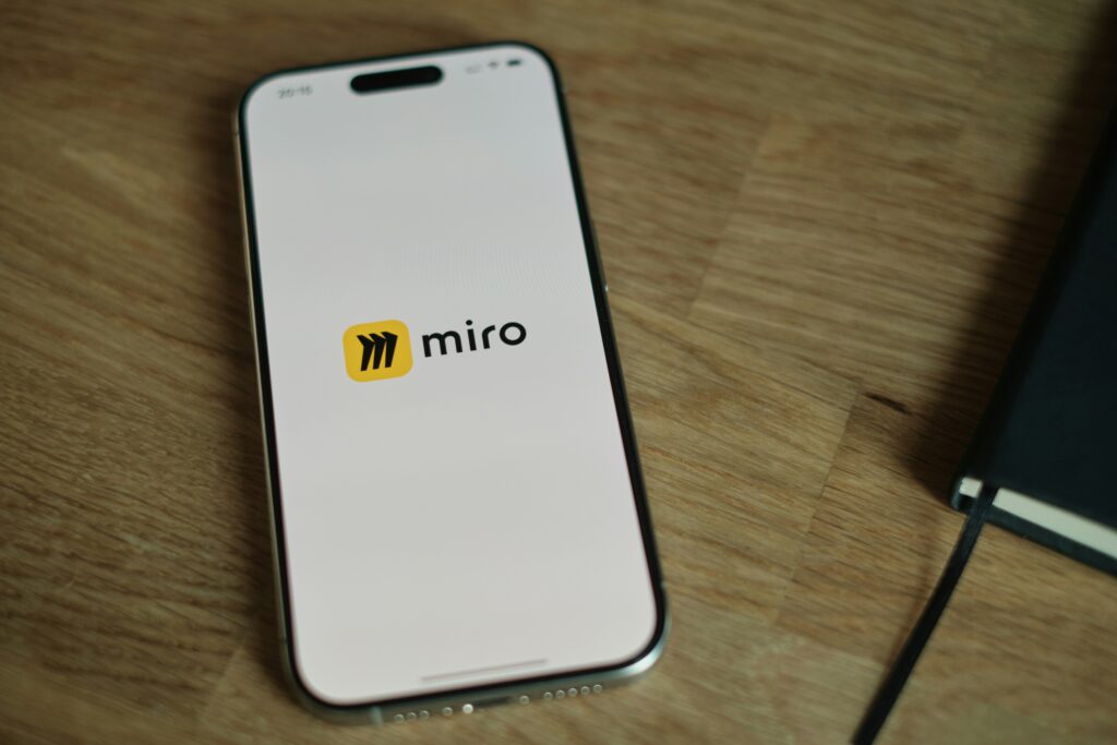 An image of an iphone with the Miro app on the screen