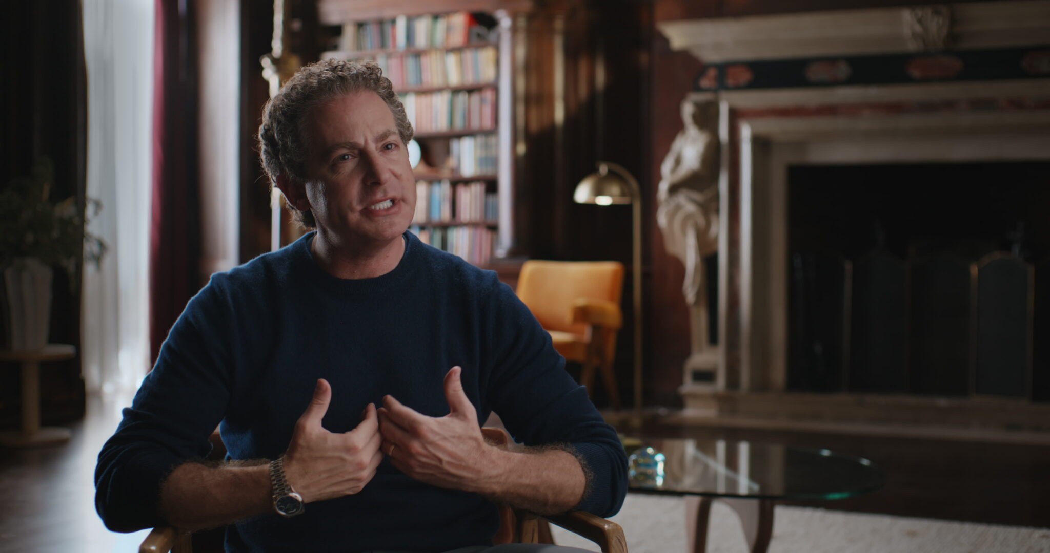 Adam Birenbaum of Focus Financial Partners in interview in a panelled library, from the Nevis × Focus announcement film