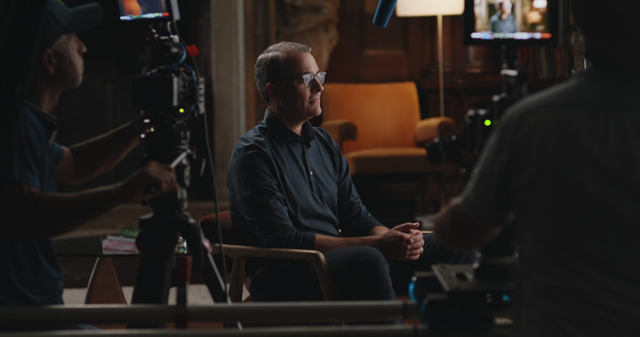 Justin Ferri of Focus Financial Partners on set, seen past the cameras and crew filming him