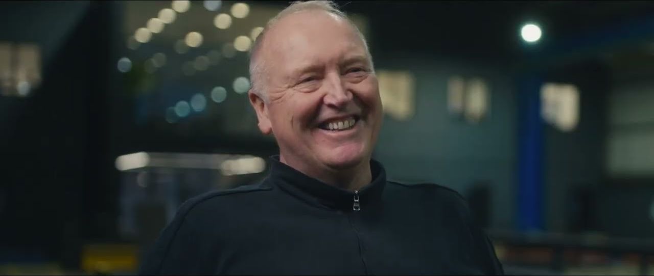A member of the JA Brooks team laughing in the workshop, from 100 Years of Trust