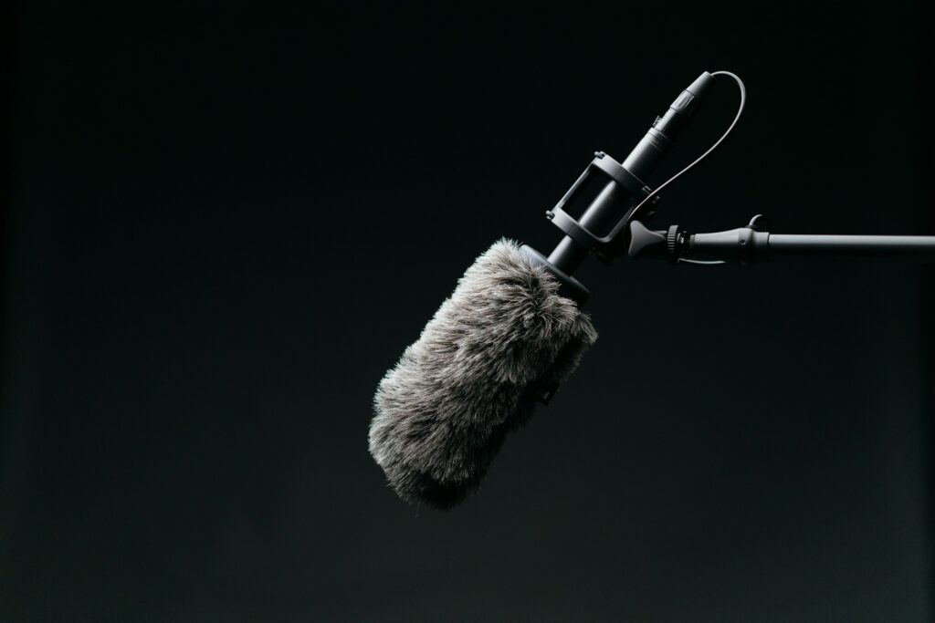 A shotgun microphone in a windshield on a boom pole