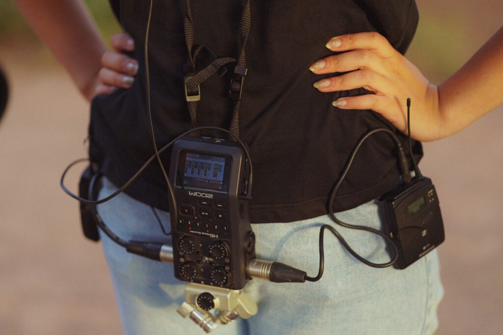 A sound recorder and radio mic receiver clipped to a crew member’s belt